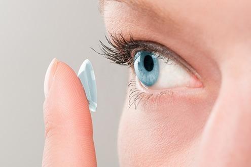 a person applying contact lenses